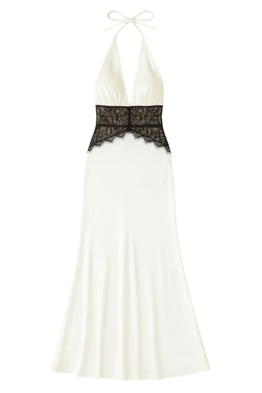 White halter neck dress with black lace detailing on a white background